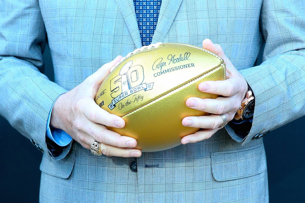 NFL Hall of Famer and Buffalo Bill Quarterback Jim Kelly carries a Gold Football with the On The Fifty Logo at the 2015 National Football League Draft. (Icon Sportswire via AP Images)