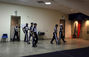 NFL Officials meet before officiating a game.