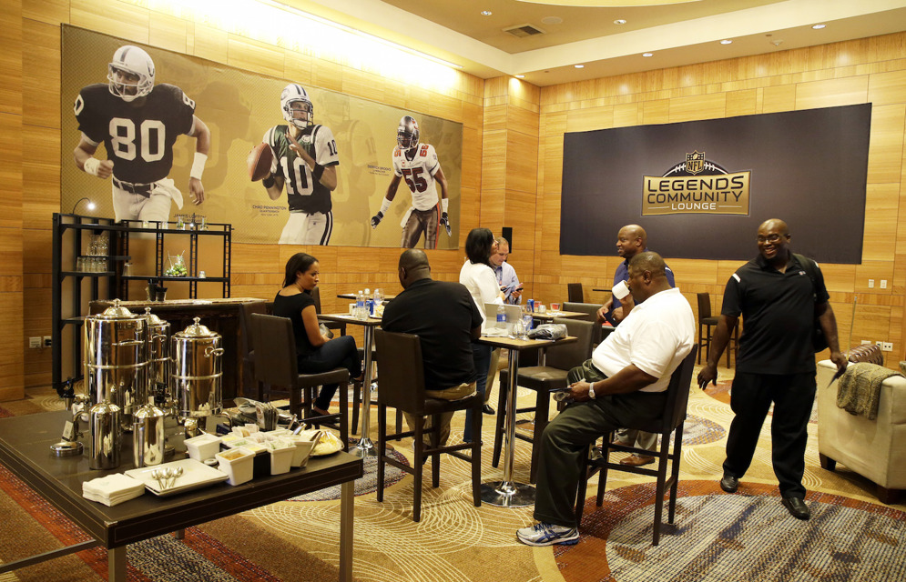 Former NFL players and guests visit in the NFL Legends Community Lounge in Seattle. (AP Photo/Ted S. Warren)