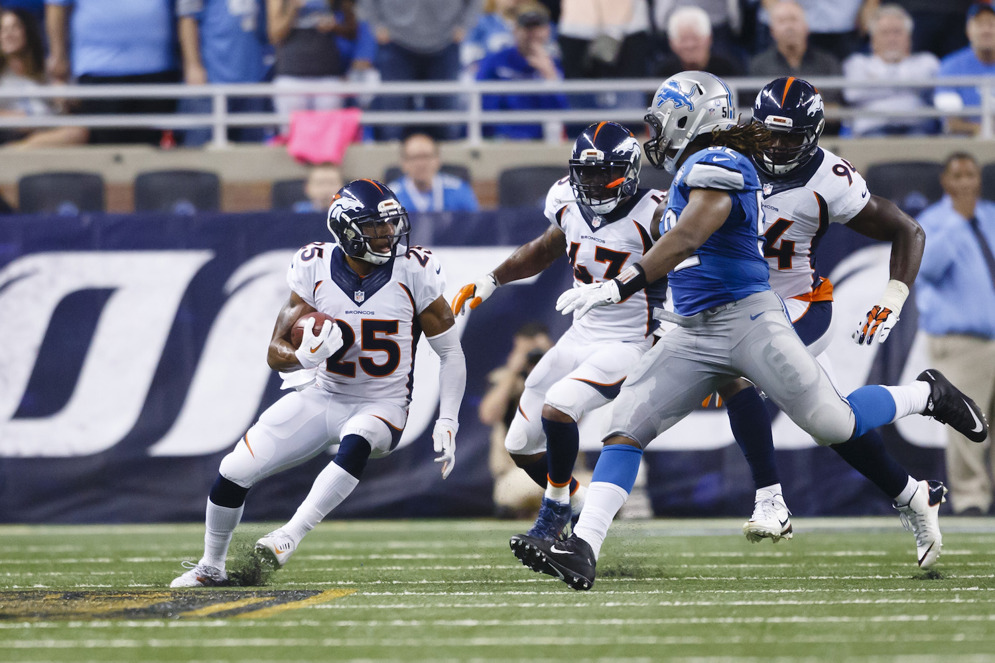 Denver Broncos cornerback Chris Harris runs the ball after a blocked extra point attempt against the Detroit Lions. (AP Photo/Rick Osentoski)