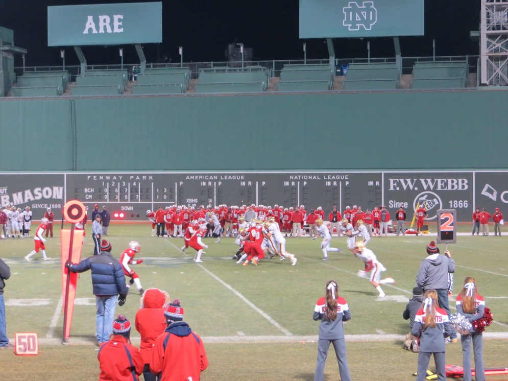Catholic Memorial (in Red) squares off against Boston College High School in the shadow of Fenway Park’s Green Monster in left field 