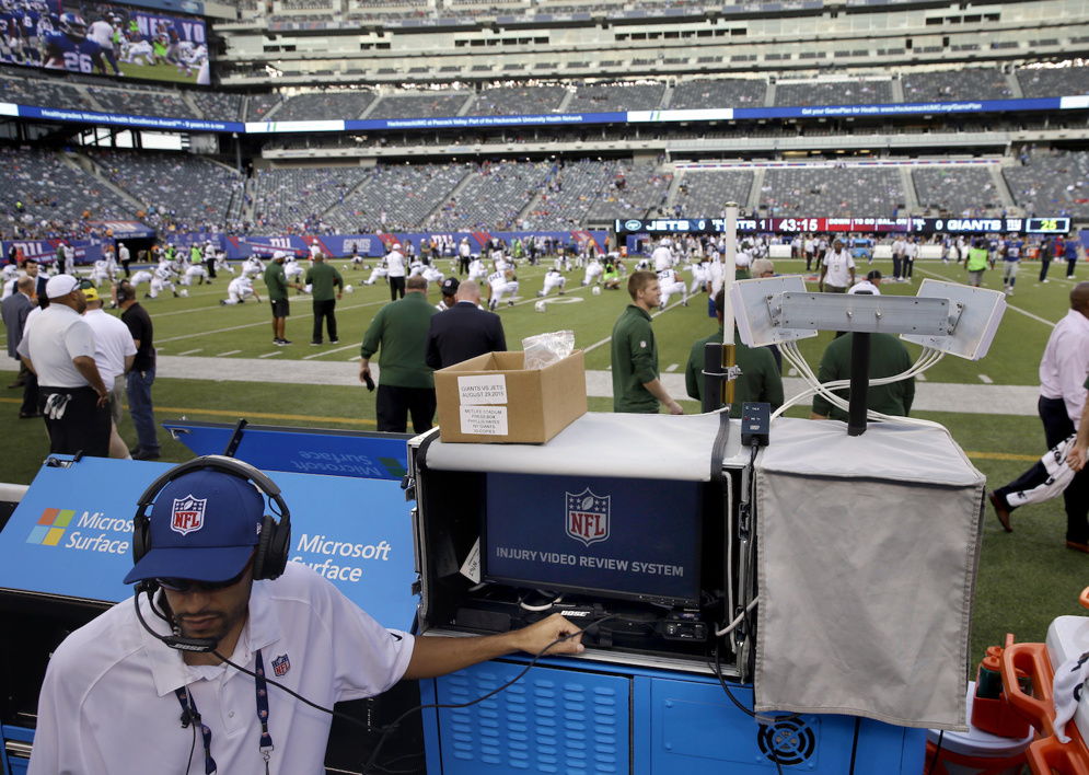 An NFL employee sets up a video review system used to help spot injuries on the field during NFL games. In 2015, the NFL gave ATC spotters in the press box the power to call a medical timeout. (AP Photo/Seth Wenig)