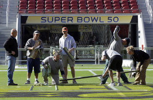NFL employees get the field ready for Super Bowl 50.