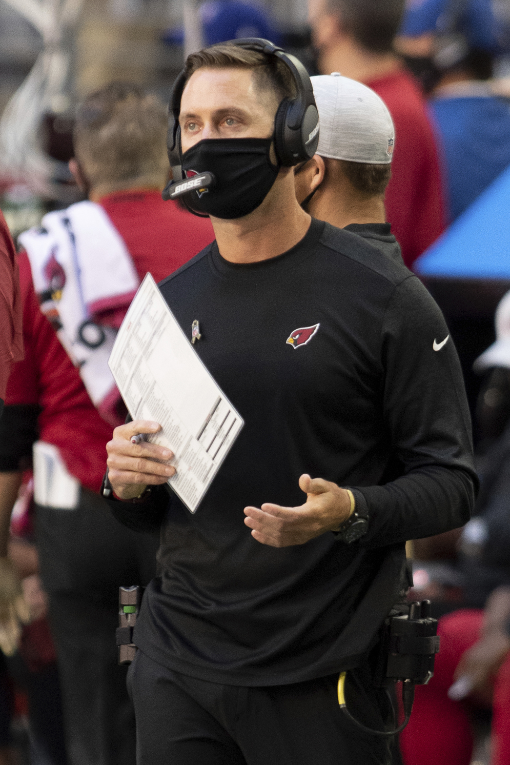 Coach-to-quarterback communications systems replaced hand signals and player substitutions as methods for coaches to relay play calls to quarterbacks. (AP/Jennifer Stewart)