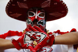 A Kansas City Chiefs fan wears a mask before an NFL football game.