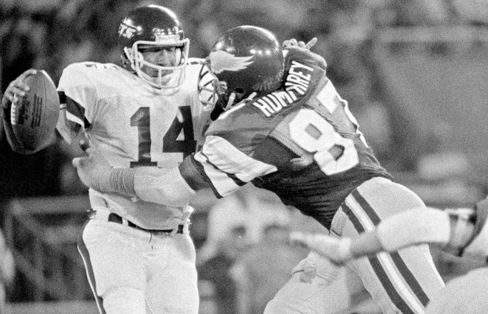 Former Atlanta Falcons defensive end Claude Humphrey gets tackled with the football.